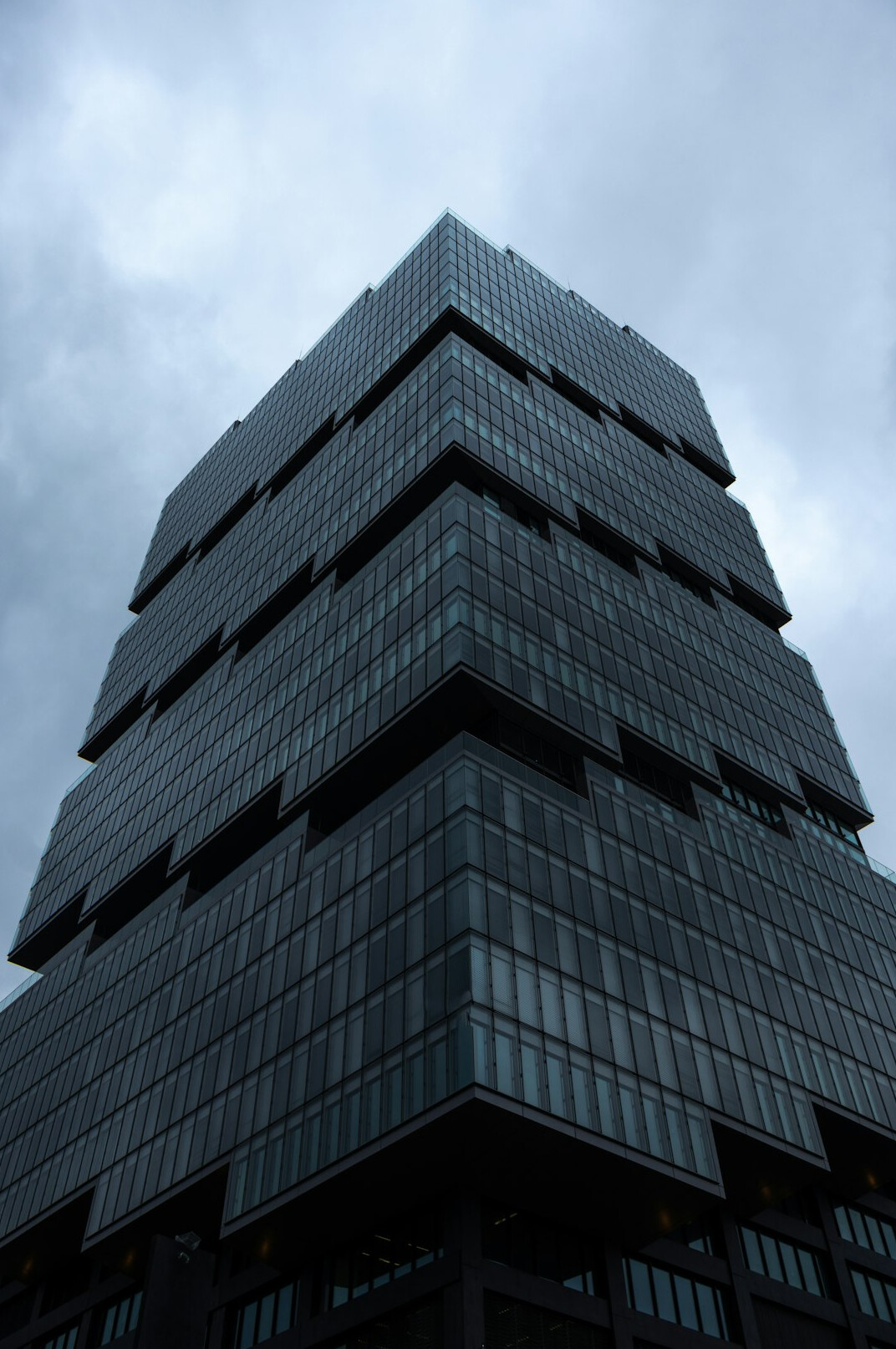 Modern office building facade with glass windows in a Swiss city